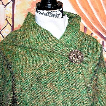 Drachen Brosche im Mammen Stil aus Bronze auf einer Schieferplatte an einem grünen Wolltuch