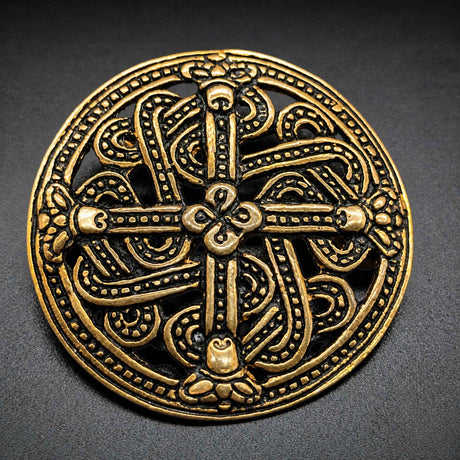 Diese Scheibenfibel aus Bronze ist im Borre-Stil gestaltet, einem charakteristischen Kunststil der Wikingerzeit. Das symmetrisch aufgebaute Ornament greift die verschlungenen Tier- und Flechtmotive auf, die für diesen Stil typisch sind.